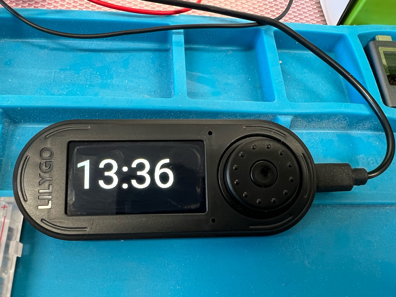 LILYGO T-Embed displaying the time beside its rotary control