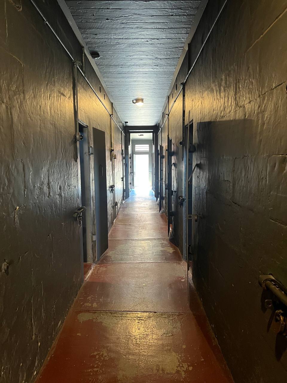 Dimly lit cell block corridor at the Old Dubbo Gaol