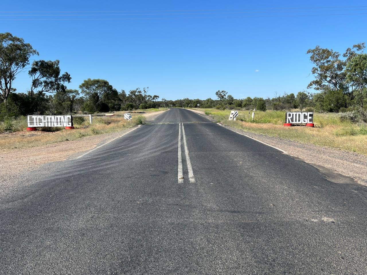 The road into Lightning Ridge, flat and straight to the horizon